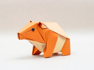 Small origami figurine in the shape of a funny hamster, paper crafts, hobby. Children's figures.