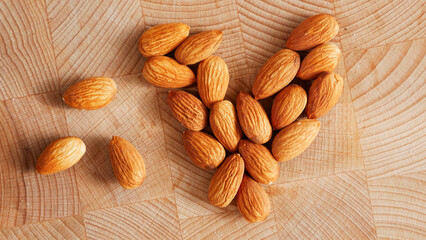 Nuts. Almonds on a wooden table in the shape of a heart. Healthy nutrition. Diet.
