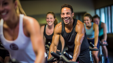 Portrait of smiling man on exercise bike with friends  in gym - obrazy, fototapety, plakaty