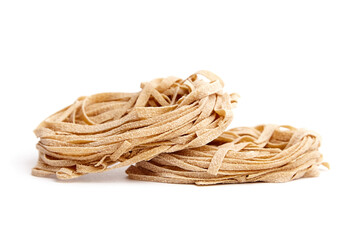 Whole grain pasta tagliatelle isolated on white background. Tagliatelle integrali, wholemeal pasta