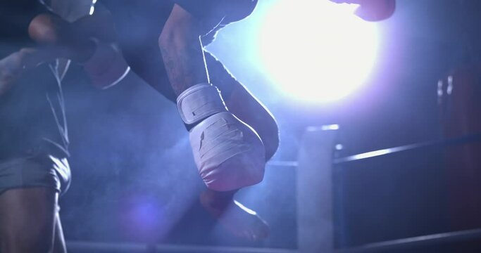 Man in Muay Thai Duel: Leg Strike Sends Boxer to Canvas, Dramatically Lit Descent Captured at 800 fps Ultra Slow-Motion