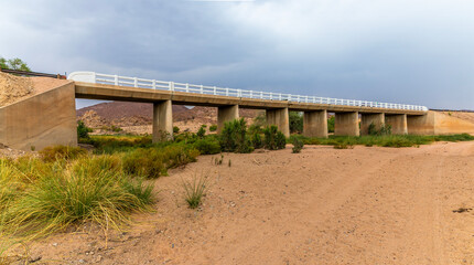 Fototapeta na wymiar A view towards the bridge over the Agab river at Oruhito in Namibia during the dry season