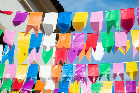 Festive decoration flags of different colors hanging with string.