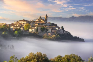 Deurstickers Trevi picturesque village in a foggy morning. Perugia, Umbria, Italy. © stevanzz