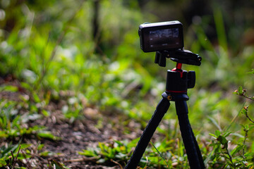 action camera on a tripod in a forest on a sunny day