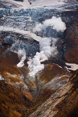 Beautiful mountain landscape, crater of active volcano: fumarole and hot spring, geothermal gas-steam activity, lava plain. Amazing volcanic landscape,