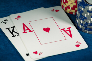 Ace of Hearts and King of Spades with chips on the poker table