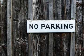No parking sign on the old wooden door