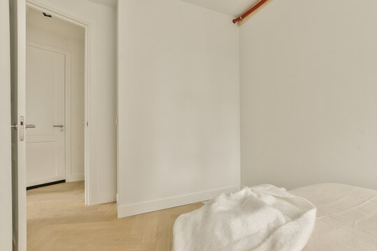 a bedroom with white walls and wood flooring in the fore - image was taken from an appreciial perspective