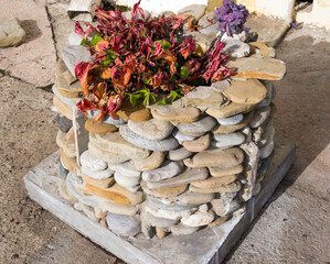 Flowerbed made of small stone pebbles