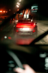 Street Pursuit
A dynamic shot from the rear seat of a following car, capturing the iconic Porsche...