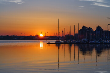 Sunrise at the Harbor of Rostock, Baltic sea, Germany, beautiful scenery with orange sky