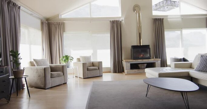 General view of modern living room with fireplace and furniture with copy space, slow motion