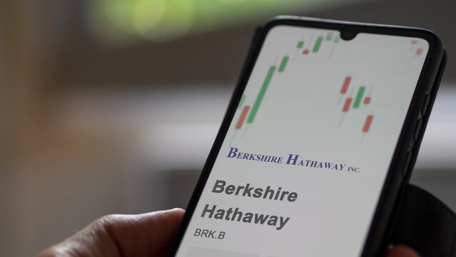 Logo of Berkshire Hathaway on the screen of an exchange. Berkshire hathaway price stocks, $BRK.B on a device.