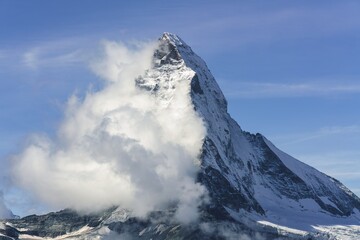 Clouds wrap the peak of Matterhorn during a lovely morning hike in Zermatt, Switzerland