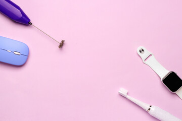 Frame made of modern gadgets on pink background