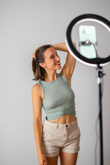 influencer girl. happy girl recording a video for social networks. She is touching her hair