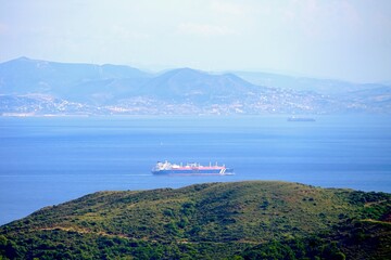 oil tanker ship passing through the Strait of Gibraltar and entering the Atlantic Ocean, seen from...