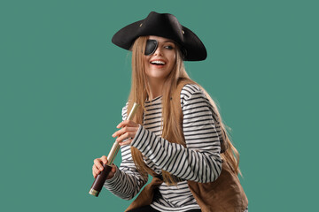 Beautiful female pirate with spyglass on green background