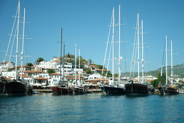 Fototapeta premium Yachts at the pier near the lighthouse.
