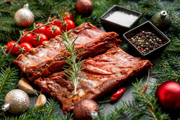 Christmas raw ribs on a background of a Christmas tree and Christmas toys