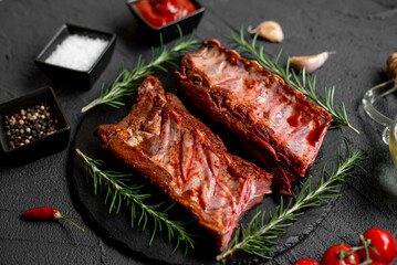 raw marinated pork ribs with spices on stone background with a copy of the space for your text