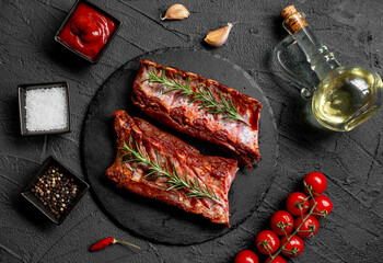 raw marinated pork ribs with spices on stone background with a copy of the space for your text