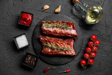 raw marinated pork ribs with spices on stone background with a copy of the space for your text