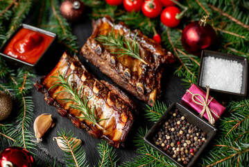 Christmas grilled pork ribs on a background of a Christmas tree and Christmas toys