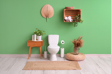 Interior of restroom with toilet bowl and table