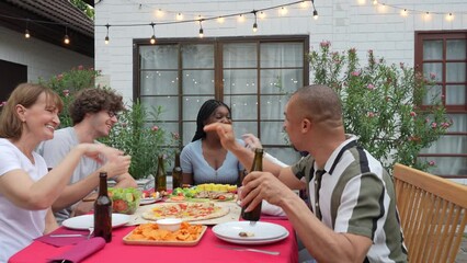 Happy family eating dinner together on holiday, Outdoor party, Celebrating Christmas and New Year's Day.