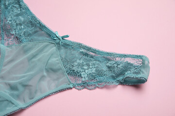 Stylish female panties on pink background, closeup
