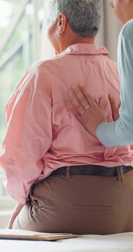Clinic, senior woman and chiropractor with back pain, healing, conversation and rehabilitation. Patient, elderly person and employee with physical therapist, spine and recovery with healthcare