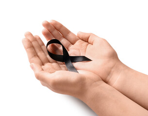 Woman holding black funeral ribbon on white background