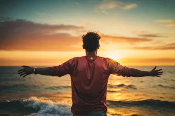 Fototapeten person with arms outstretched, has achieved its goals, beach sunset background © Alex