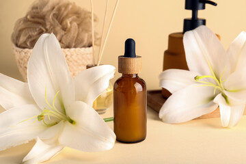 Fototapeta na wymiar Bottle of essential oil, spa accessories and lily flowers on color background