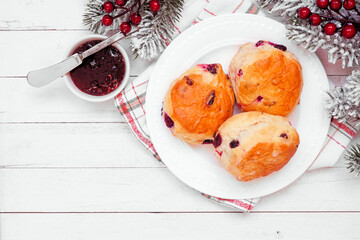 Fresh Cranberry scones with jam. Above view over a white wood background with copy space. Christmas...