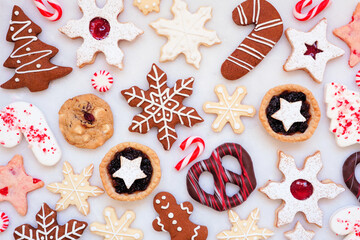 Christmas baking background with an assortment of cookies and sweet treats. Top down view on a...