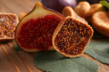 Sweet dried figs and fresh fruit on wooden background