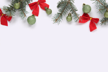 Composition with fir branches and Christmas decorations on light background