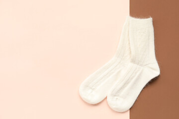 Warm socks on color background