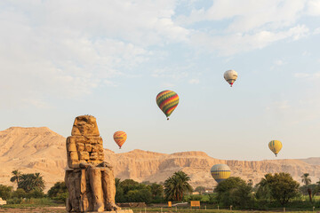 Colossi of Memnon in Egypt: Majestic ancient statues guarding the historical wonders of Luxor,...