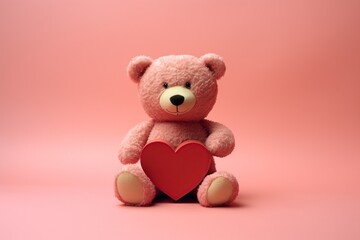 Valentines Day big Teddy bear holding a red heart in pink background 