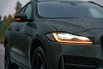 front of jaguar f-pace on the road on rainy day