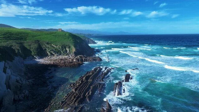 Coastal landscape with waves around El Sable beach in the town of Tagle. Aerial view from a drone. Suances Municipality. Cantabrian Sea. Cantabria. Spain. Europe