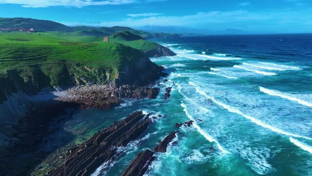 Coastal landscape with waves around El Sable beach in the town of Tagle. Aerial view from a drone. Suances Municipality. Cantabrian Sea. Cantabria. Spain. Europe