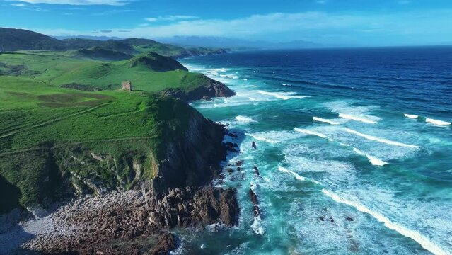 Coastal landscape with waves around El Sable beach in the town of Tagle. Aerial view from a drone. Suances Municipality. Cantabrian Sea. Cantabria. Spain. Europe
