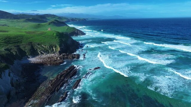 Coastal landscape with waves around El Sable beach in the town of Tagle. Aerial view from a drone. Suances Municipality. Cantabrian Sea. Cantabria. Spain. Europe