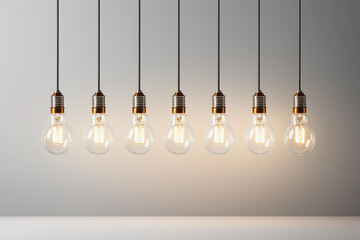 A row of glowing light bulbs suspended against a soft gradient backdrop