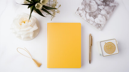 A sleek and minimalistic workspace setup featuring a vibrant yellow notebook